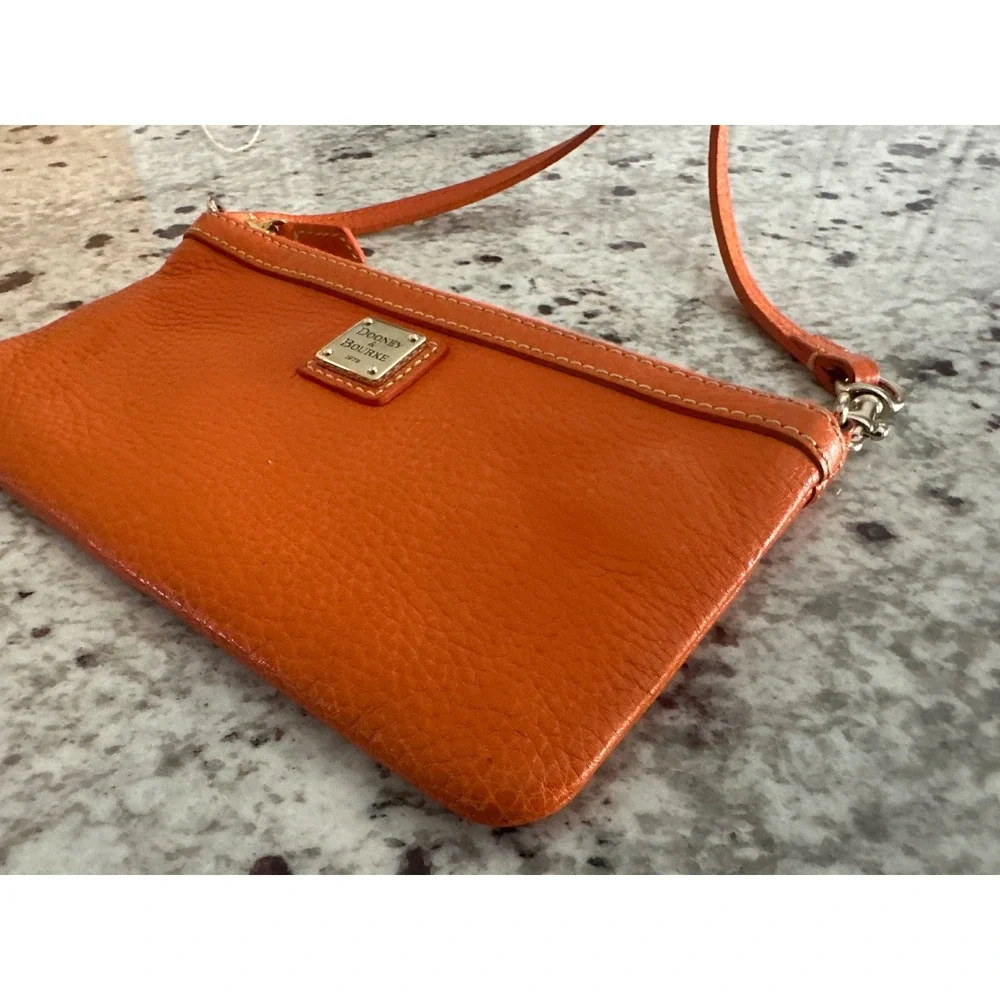 Dooney & Bourke pebble grain large slim wristlet bag in orange